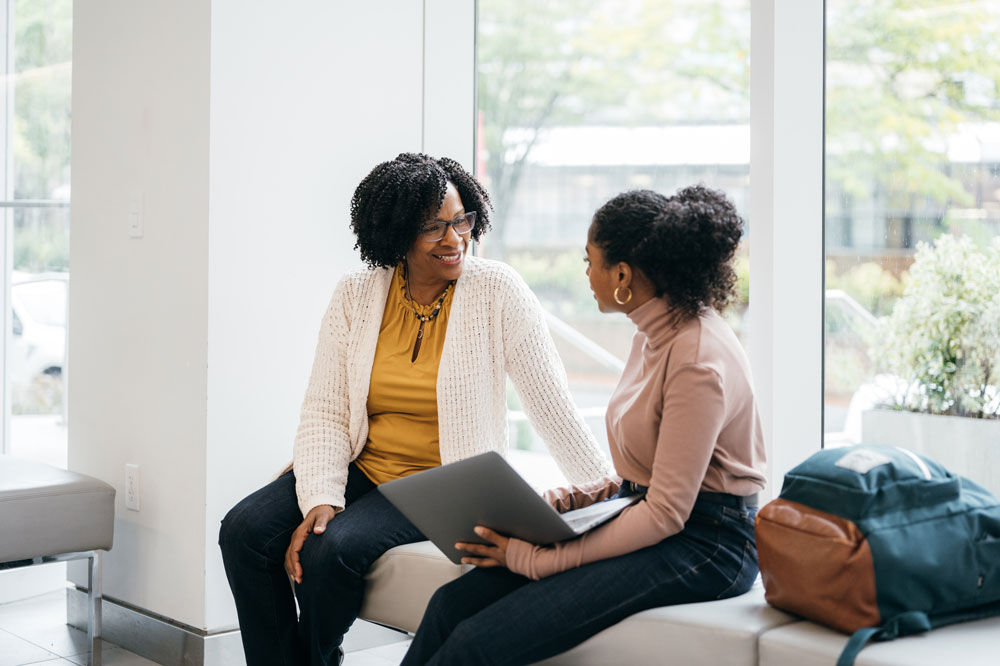Conversation between two women in a bright lounge