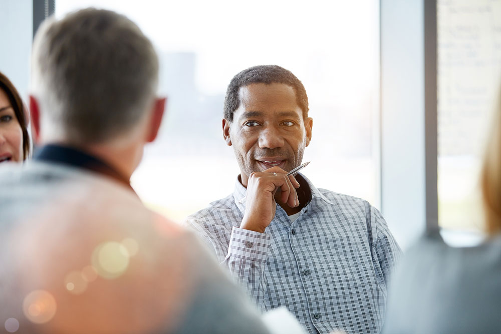Man focused on a conversation during a collaborative activity
