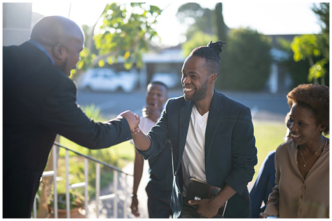 Warm outdoor welcome among a small group.
