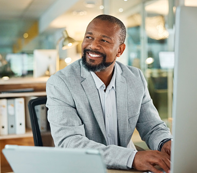 Man smiling while working at desk.