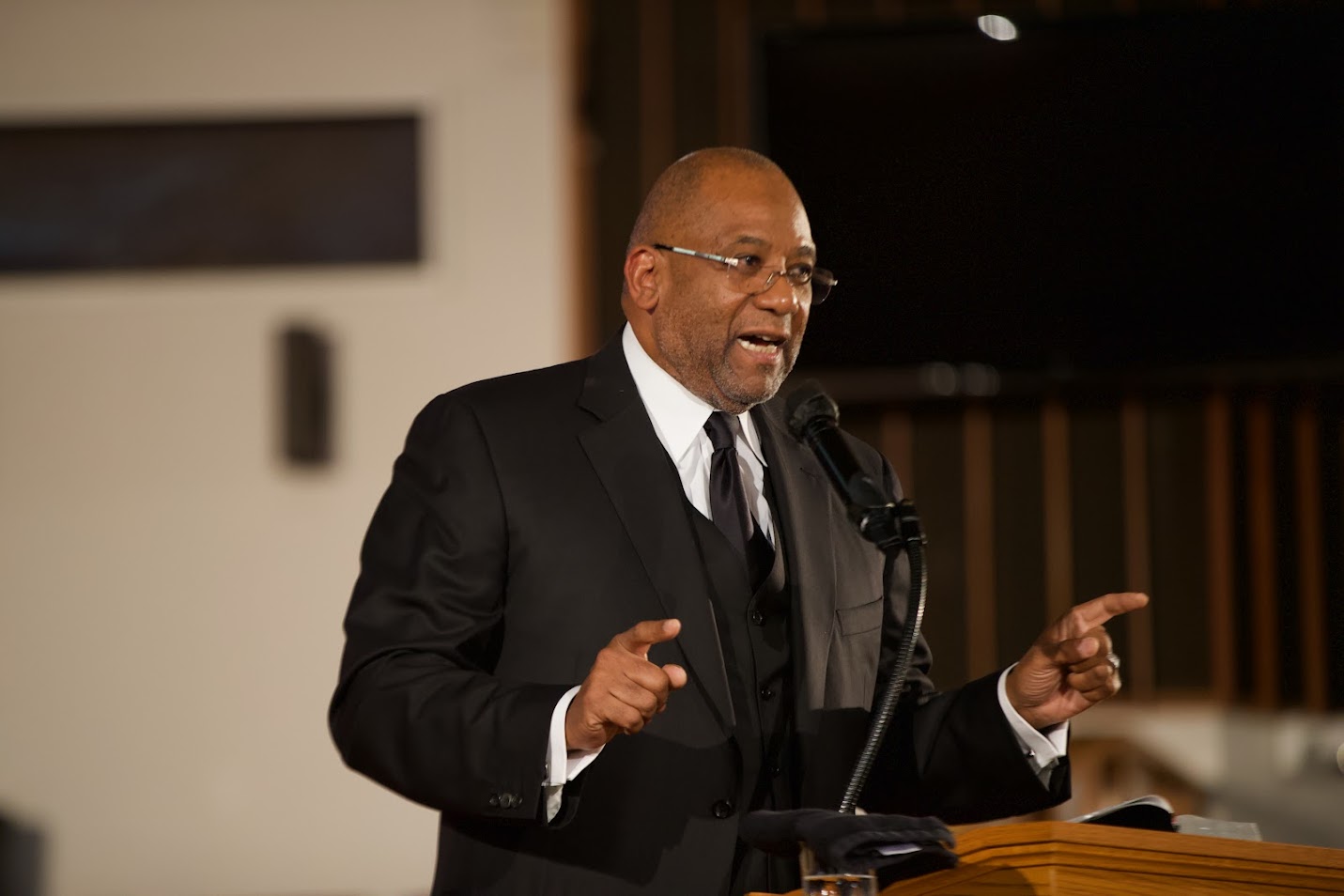 Ralph West delivering a sermon from the pulpit.