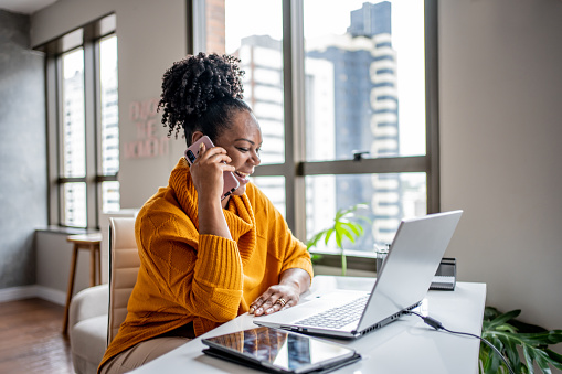 Woman talking on the phone at home